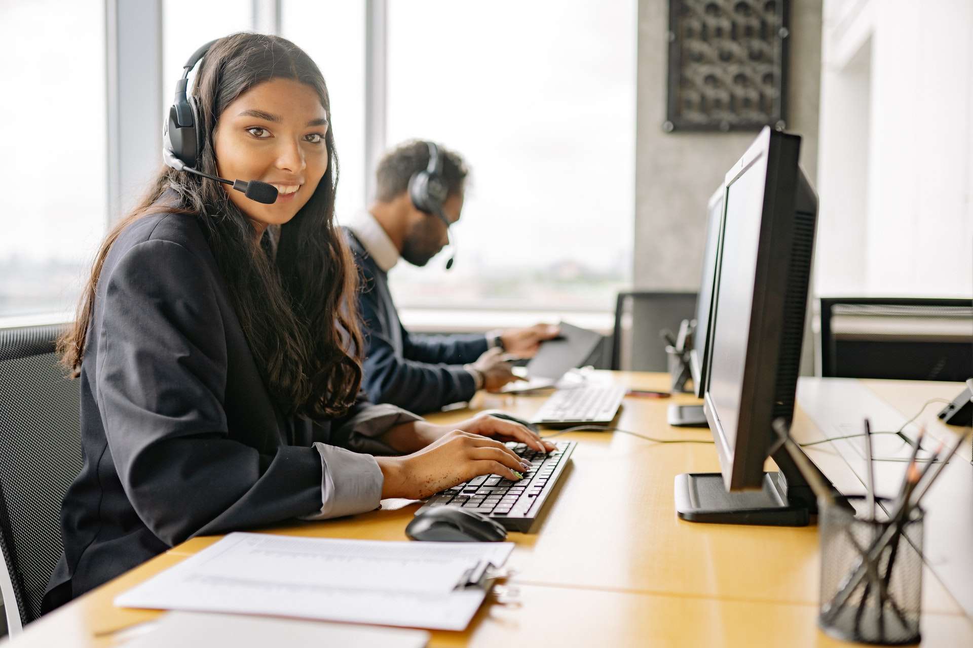 A customer care looking at the camera while working.