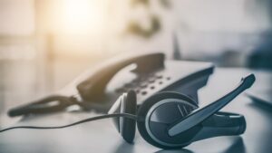 A headset laying on the table in a call center office.